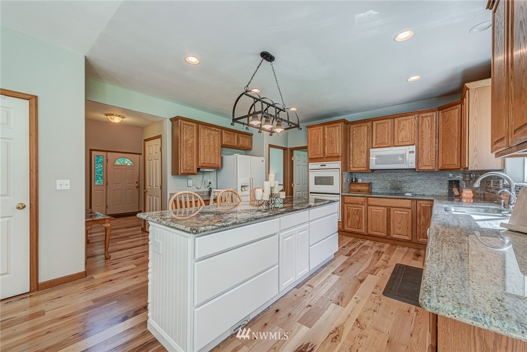 16108 OK Mill Road Snohomish, WA 98290 - Photo 7 of 23 a kitchen with stainless steel appliances granite countertop a sink stove and refrigerator