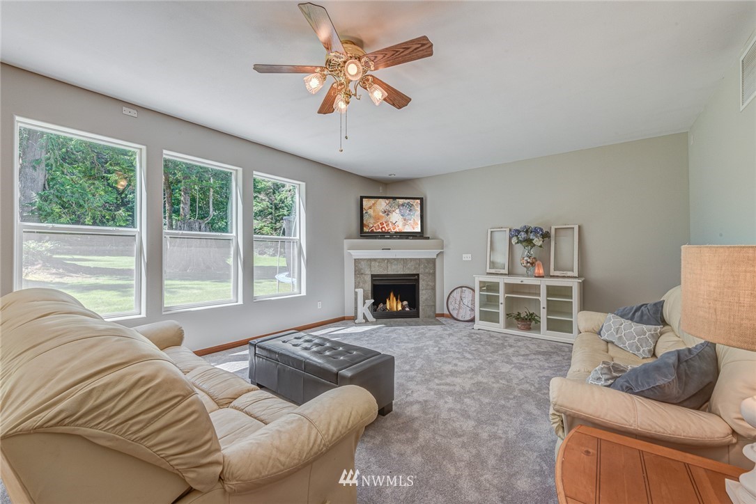 16108 OK Mill Road Snohomish, WA 98290 - Photo 10 of 23 a living room with furniture large window and a fireplace