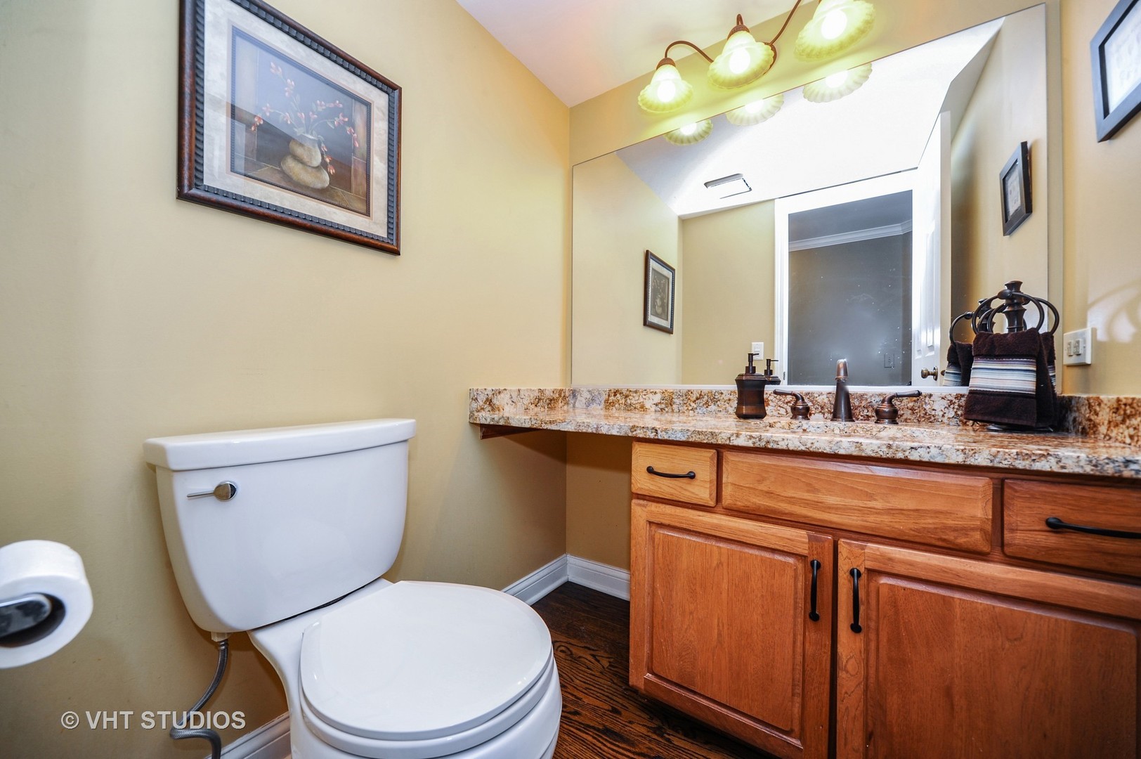 630 Raintree Road Buffalo Grove, IL 60089 - Photo 19 of 26 a bathroom with a granite countertop toilet sink and a mirror