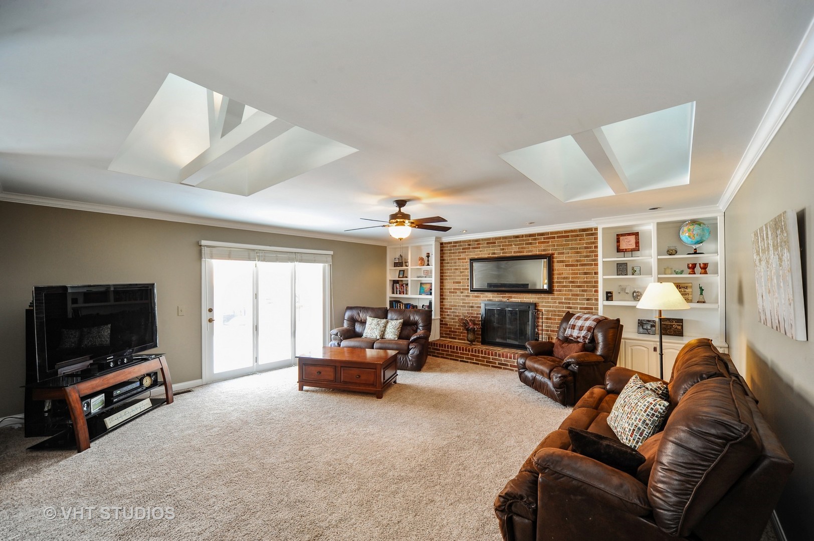 630 Raintree Road Buffalo Grove, IL 60089 - Photo 7 of 26 a living room with furniture and a flat screen tv