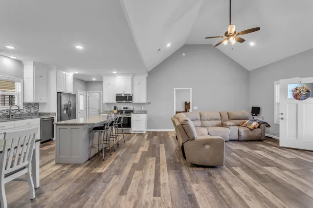a view of a house with swimming pool and a yard