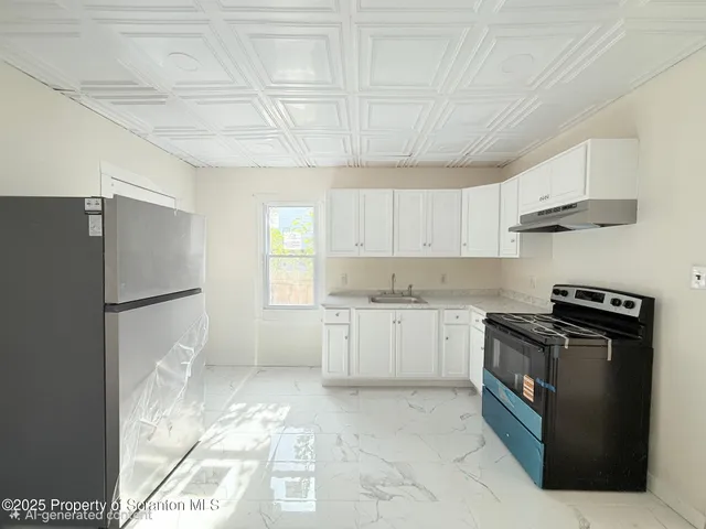 a kitchen with a stove a refrigerator and a sink