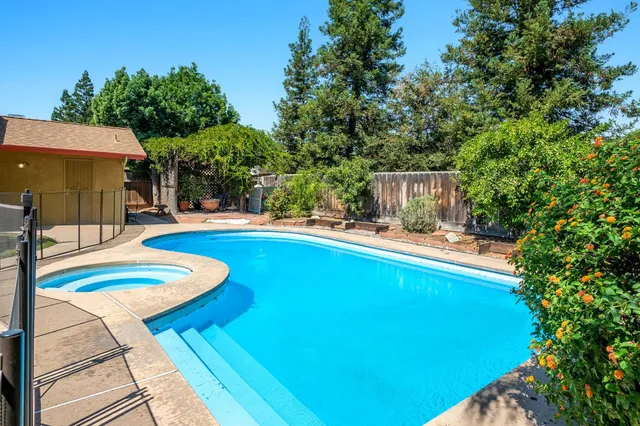 a view of a swimming pool with a patio
