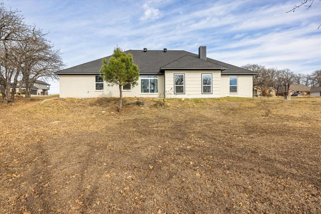 4801 West Wedgefield Road Granbury, TX 76049 - Photo 34 of 40 a front view of a house with a yard
