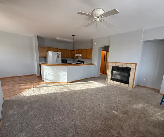 a view of a kitchen with a stove and a fireplace