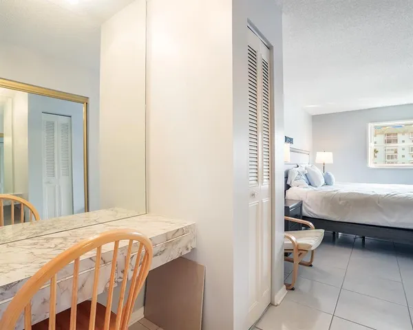 a bedroom with a bed and a mirror