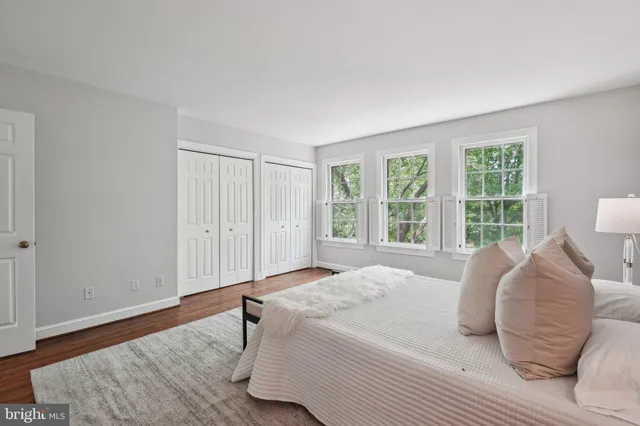 a bedroom with a bed and a large window