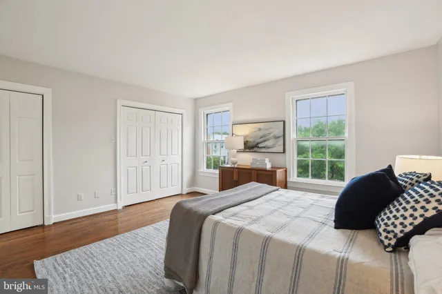 a spacious bedroom with a bed and a large window