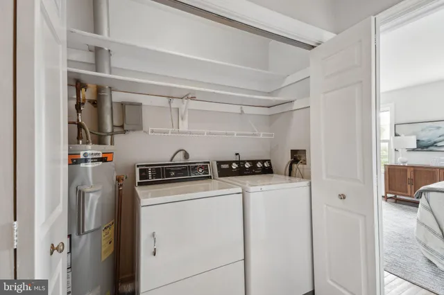 a bathroom with a sink a mirror a toilet and a window