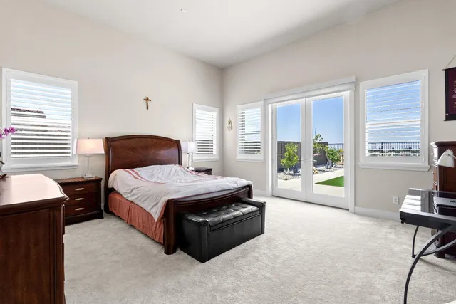 a bedroom with a bed and a chandelier