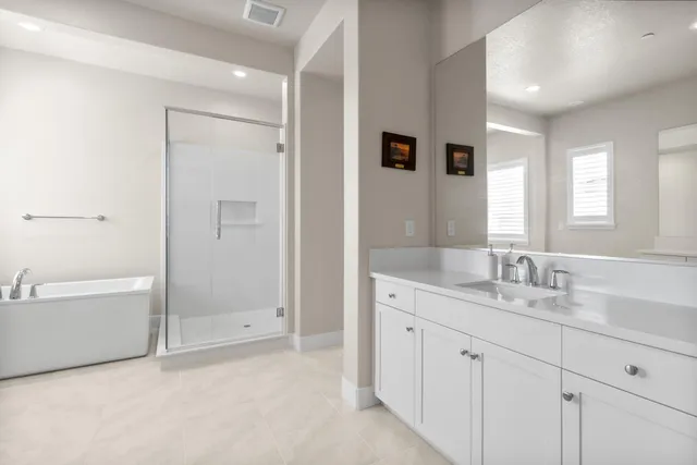 a spacious bedroom with a bed and a window