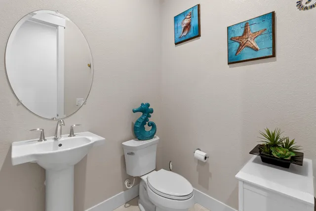 a bathroom with a toilet a sink and mirror