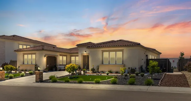 a large kitchen with granite countertop a sink a counter top space appliances and cabinets