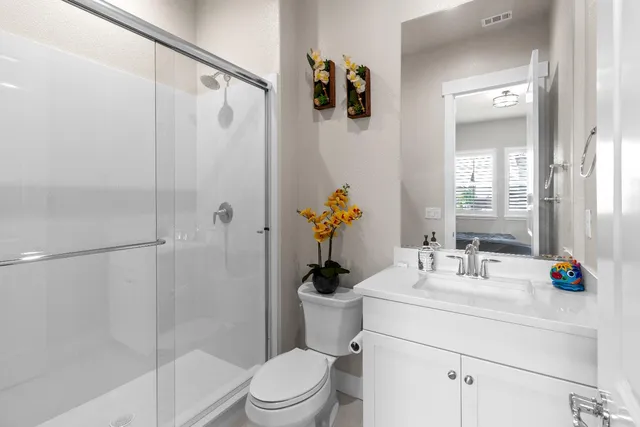 an aerial view of residential houses with outdoor space and street view