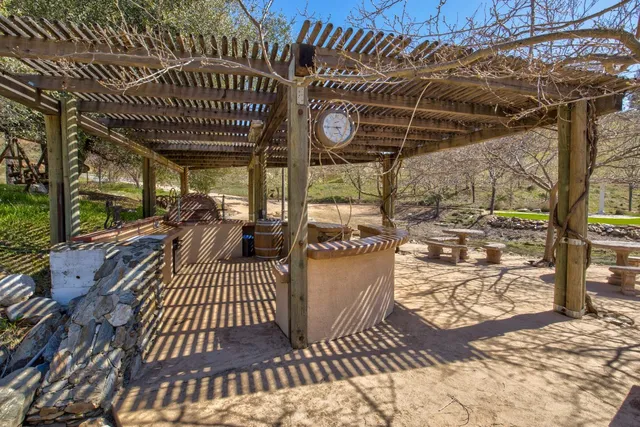 a view of dirt yard with a large tree