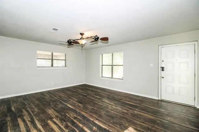 wooden floor in an empty room with a window