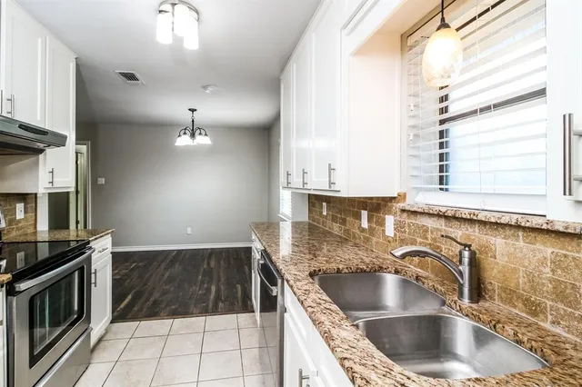 a kitchen with a sink cabinets and window