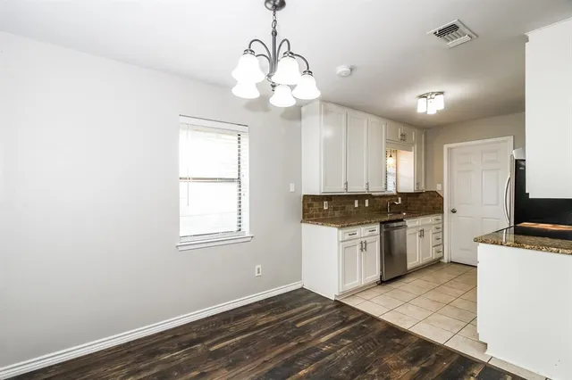 a kitchen with a refrigerator and a sink
