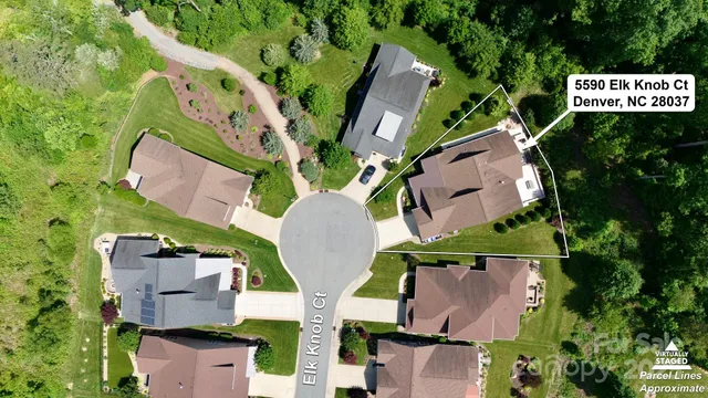 an aerial view of a house with a yard and garden