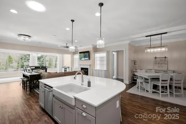 a kitchen with stainless steel appliances granite countertop a kitchen island a stove and a wooden floors