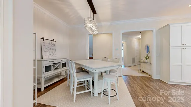 a view of a kitchen area with furniture and wooden floor