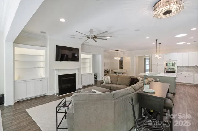 a living room with furniture a fireplace and a flat screen tv
