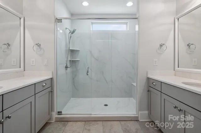 a bathroom with a shower sink and mirror