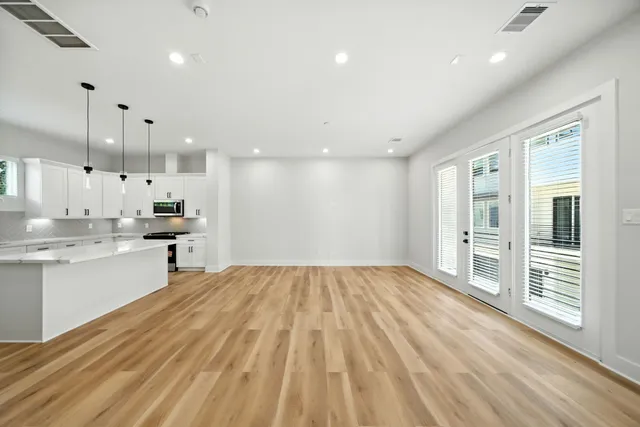a kitchen with a sink a stove a refrigerator and white cabinets