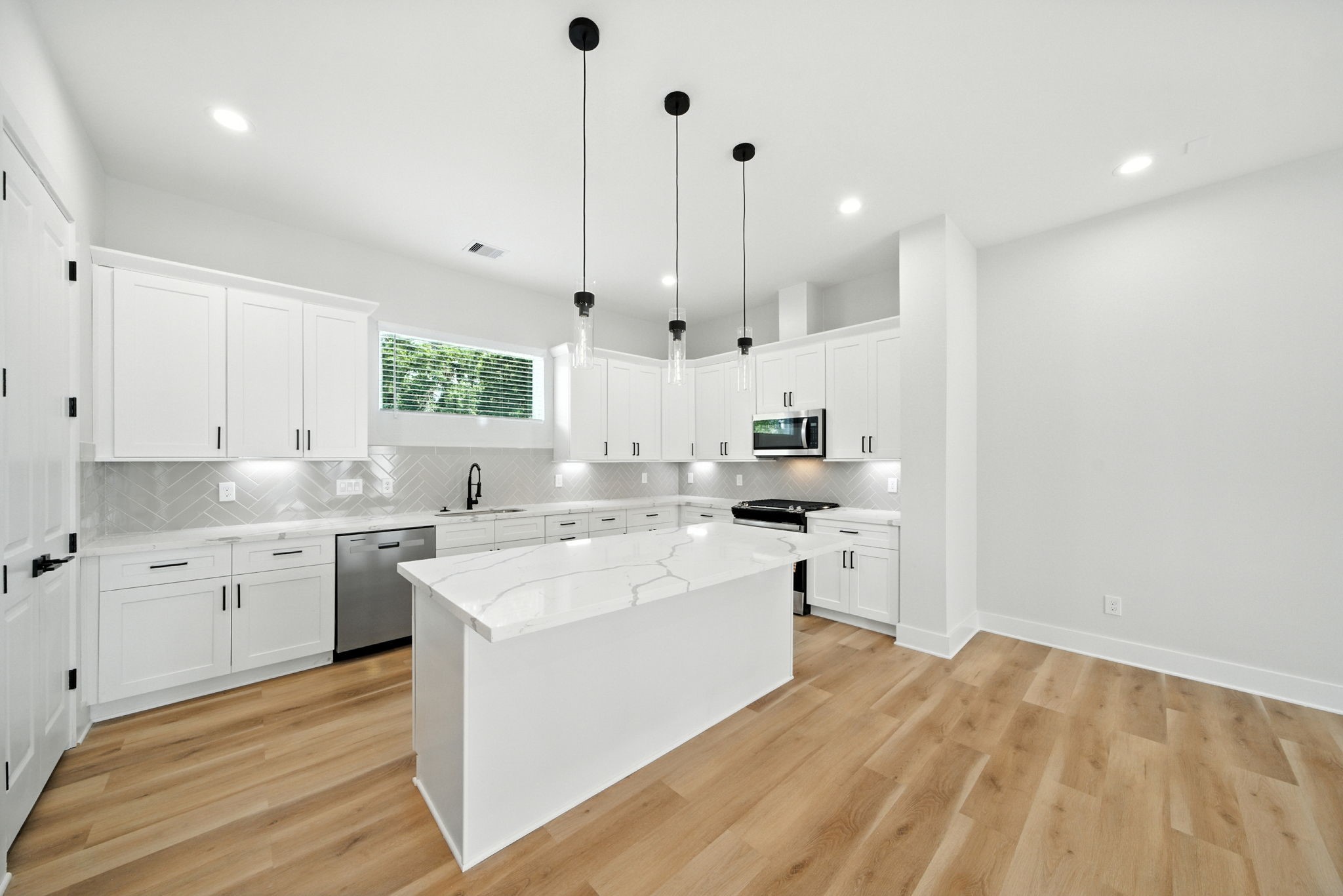 2304 Hoskins Drive, Unit D Houston, TX 77080 - Photo 21 of 41 a kitchen with a sink a stove a refrigerator and white cabinets