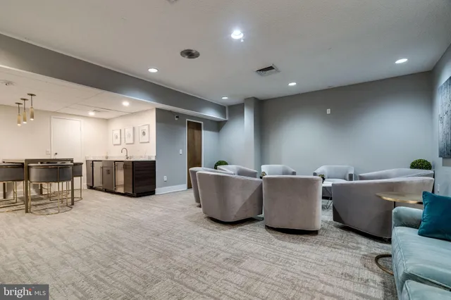 a living room with furniture and a dining table