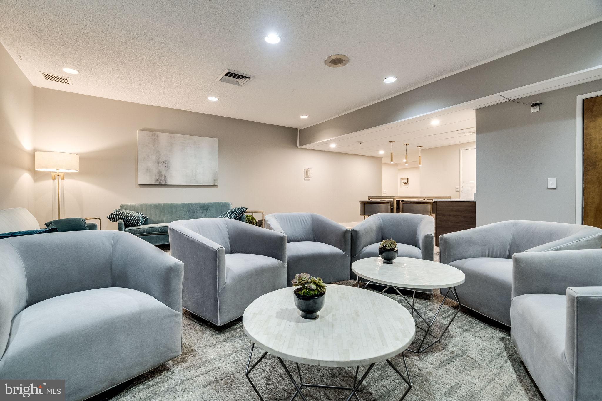 6101 Edsall Road, Unit 1202 Alexandria, VA 22304 - Photo 14 of 23 a living room with furniture and a dining table