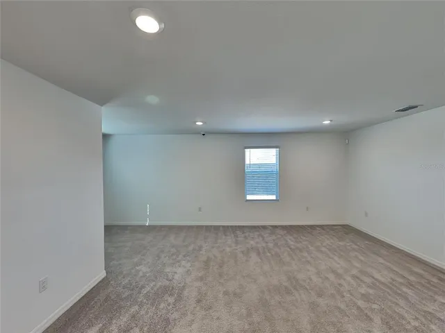 an empty room with a empty space and window