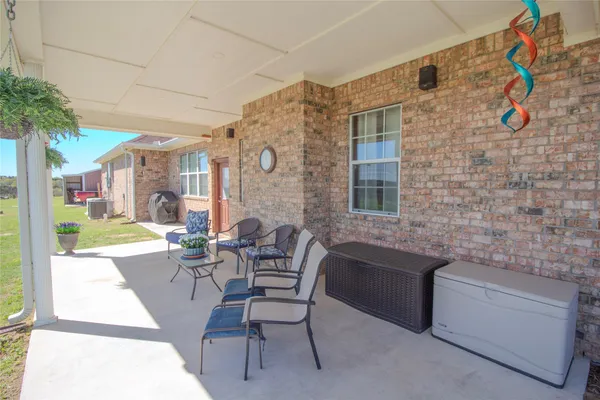a balcony with furniture and a potted plant
