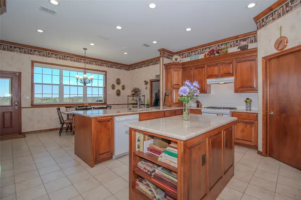 a kitchen with stainless steel appliances granite countertop a sink and a stove
