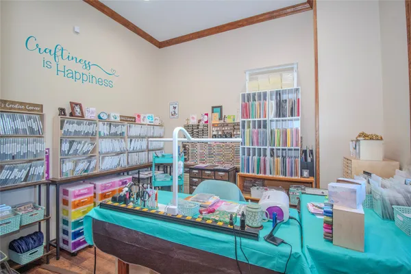 a room with lots of books and a large window
