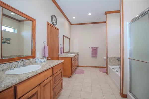 a bathroom with a granite countertop sink mirror and a shower