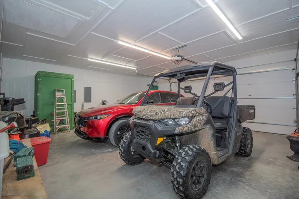 a bedroom with a bed and a car
