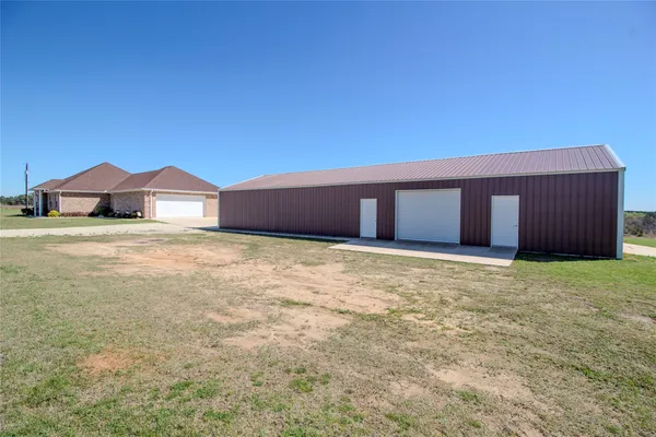 a front view of house with yard and garage