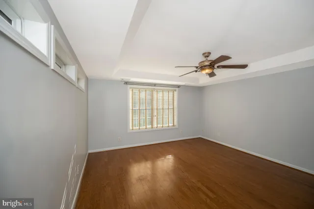 a spacious bathroom with a double vanity sink a toilet and a mirror