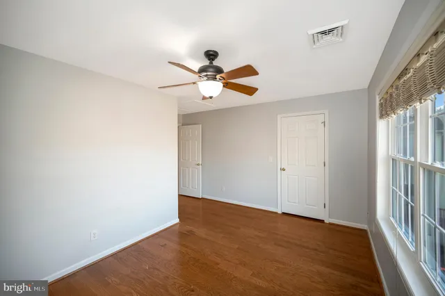 a view of a kitchen with wooden floor and electronic appliances