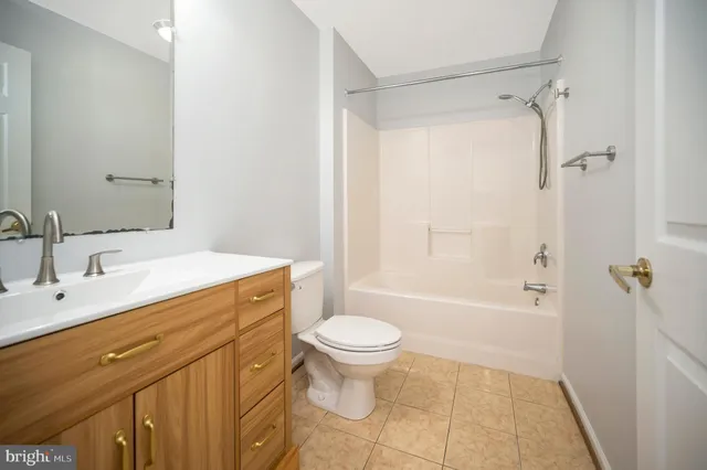 a kitchen with a sink a microwave and cabinets