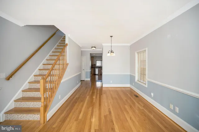 a view of entryway and hall with wooden floor