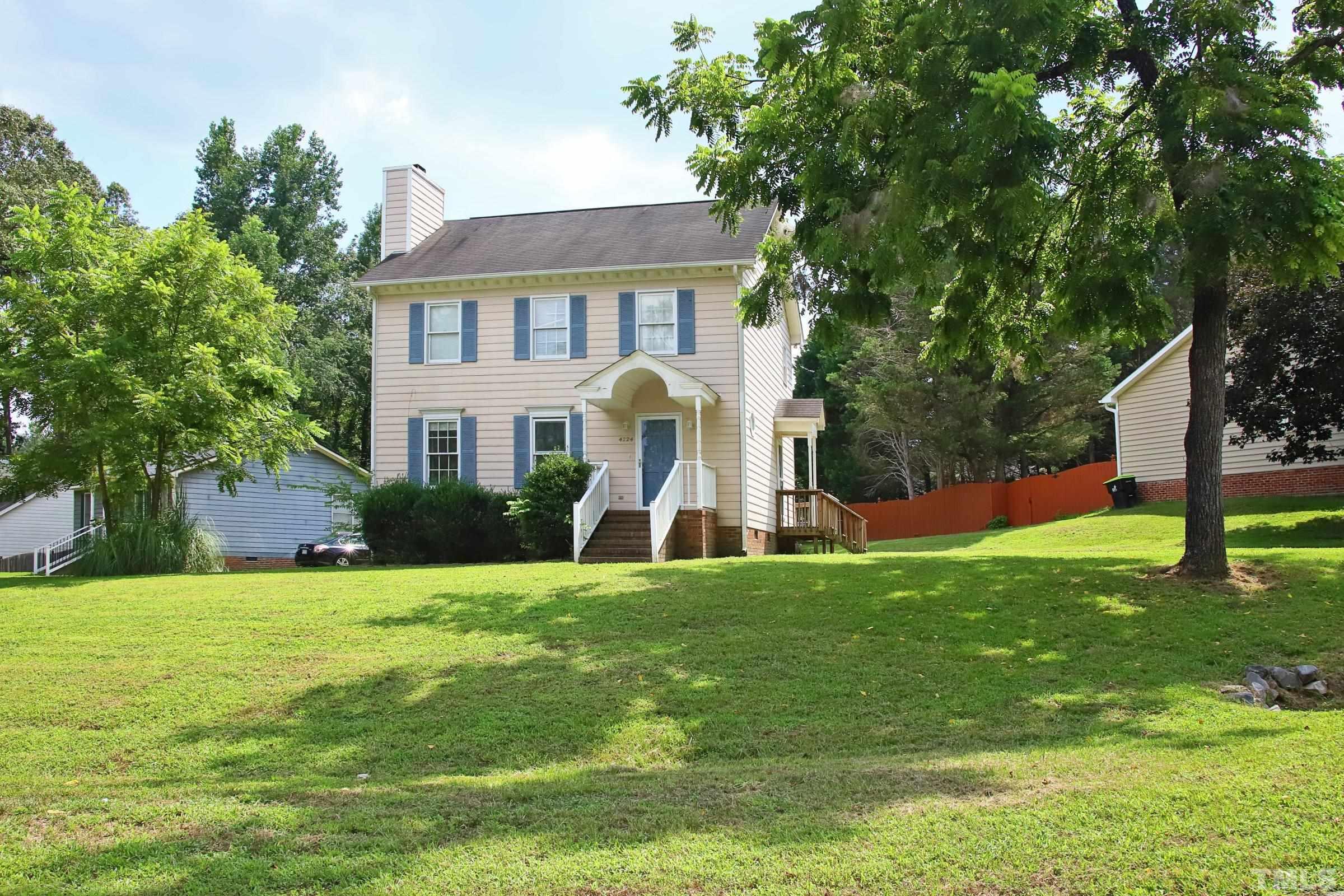 4224 Bluewing Road Raleigh, NC 27616 - Photo 2 of 29 a view of a white house with a big yard and large trees