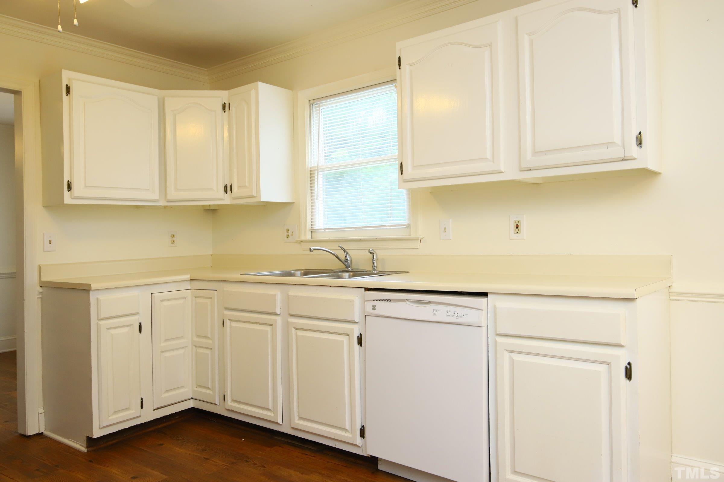 4224 Bluewing Road Raleigh, NC 27616 - Photo 12 of 29 a kitchen with white cabinets and sink