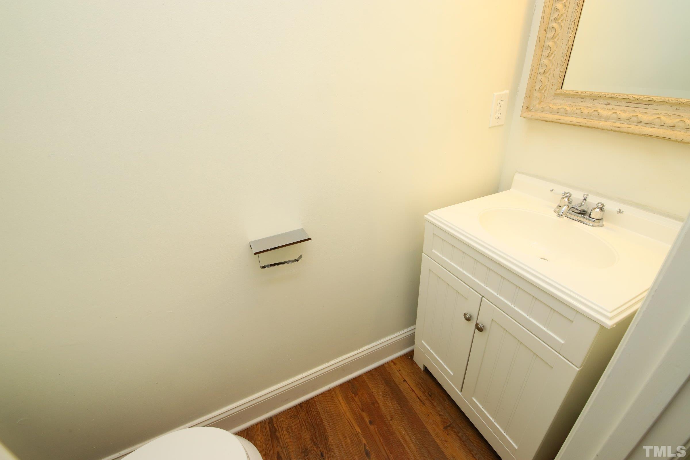 4224 Bluewing Road Raleigh, NC 27616 - Photo 14 of 29 a bathroom with a sink and a mirror