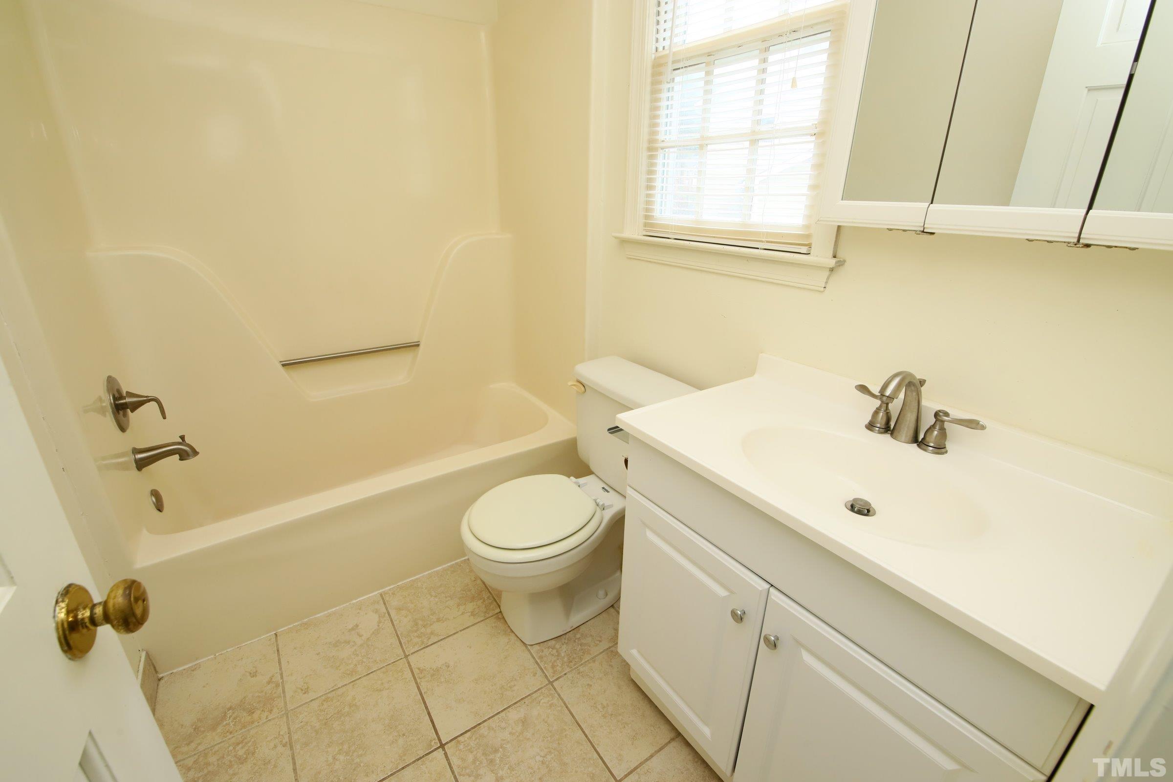 4224 Bluewing Road Raleigh, NC 27616 - Photo 23 of 29 a bathroom with a sink a toilet and bathtub
