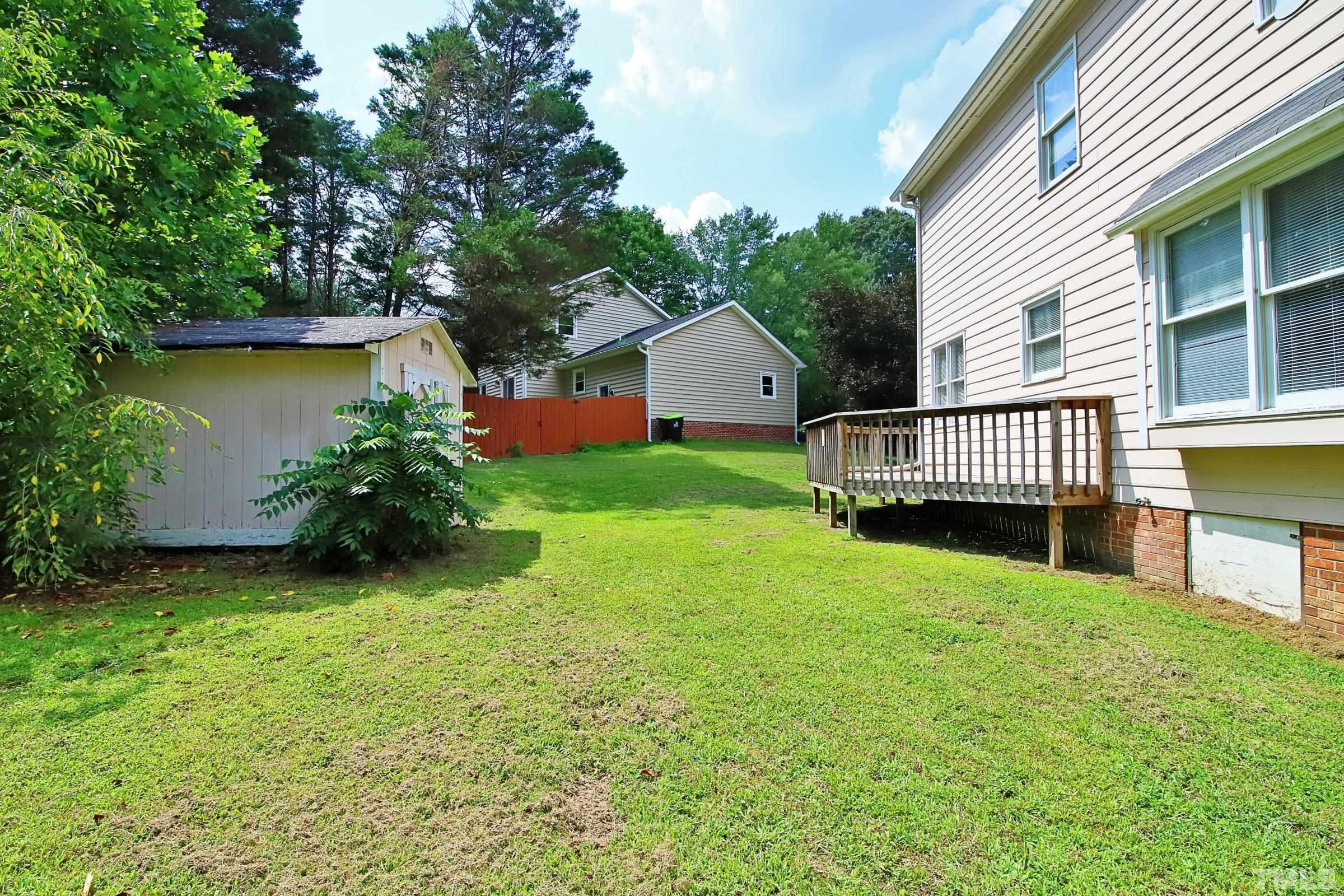 4224 Bluewing Road Raleigh, NC 27616 - Photo 29 of 29 a view of a house with a yard and a garden