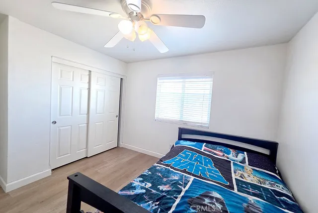 a bedroom with bed and a window