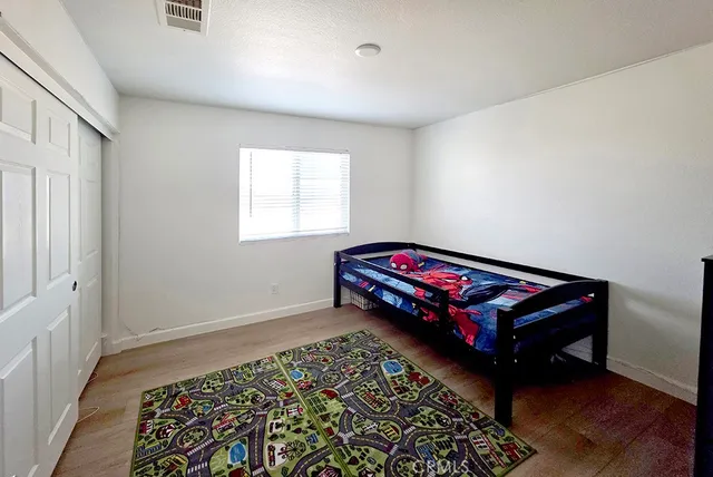 a bedroom with a bed and window