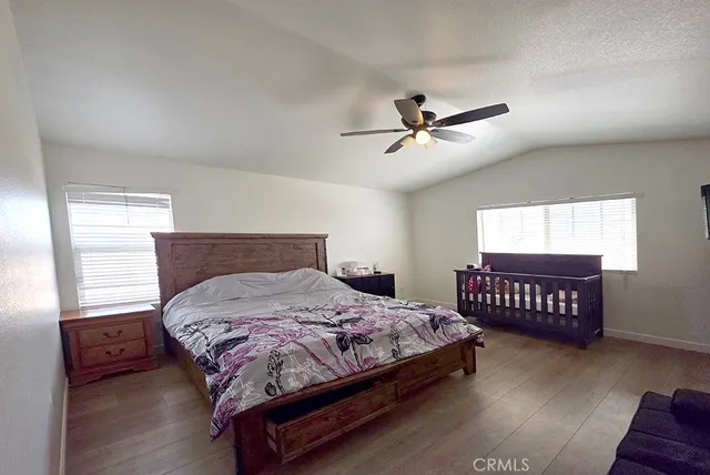 a bedroom with a bed and a ceiling fan